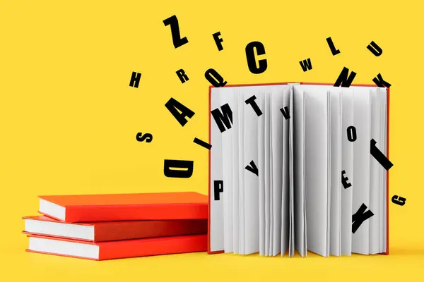 Books and many English letters on yellow background