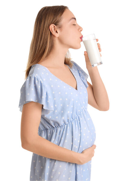 Young pregnant woman drinking milk on white background
