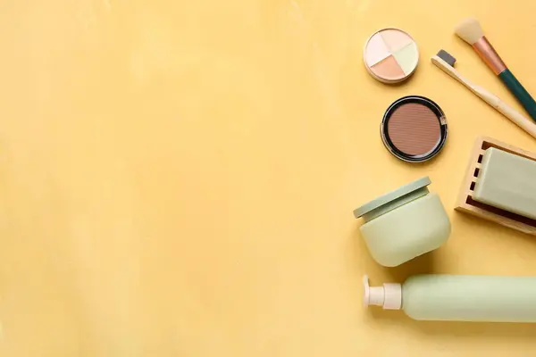 Set of different cosmetic products on yellow background