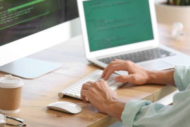 Ofiste bilgisayarla çalışan erkek programcı, yakın plan.