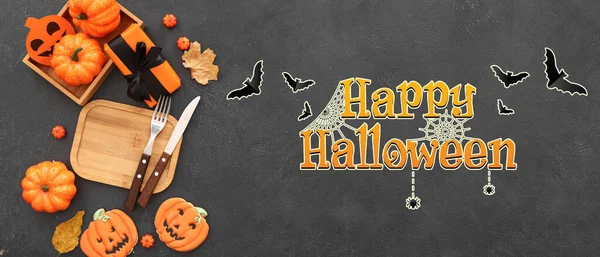 Halloween banner with creative table setting on dark background