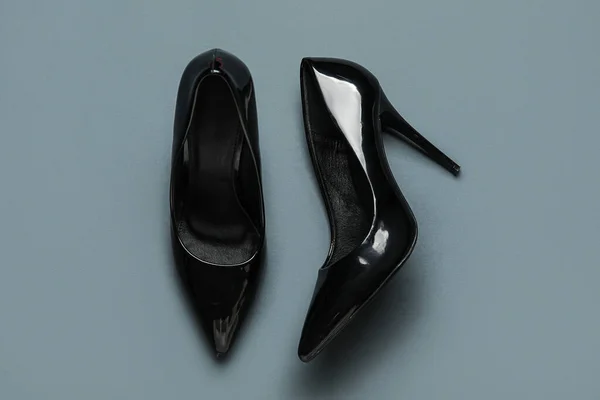 Stylish black high heels on grey background