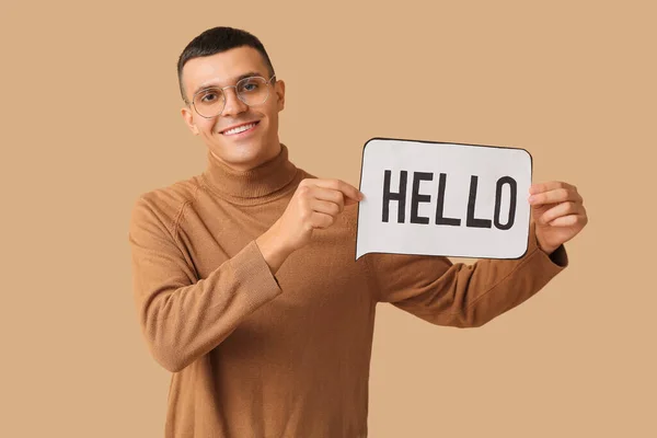Handsome Young Man Holding Speech Bubble Word Hello Brown Background — Stock Photo, Image