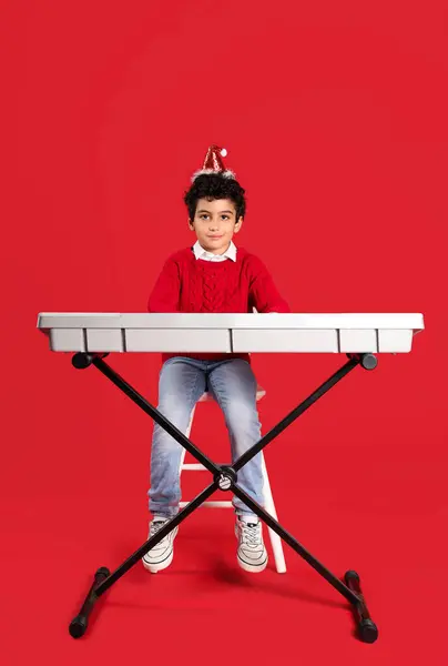 Cute Little Boy Santa Hat Playing Synthesizer Red Background — Stock Photo, Image