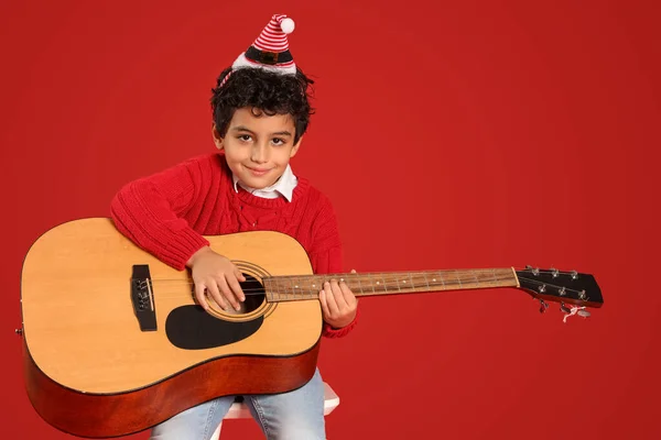 Cute Little Boy Santa Hat Playing Guitar Red Background — Stock Photo, Image