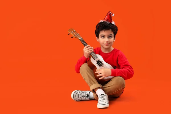 Cute Little Boy Santa Hat Playing Guitar Orange Background — Stock Photo, Image