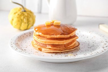 Ballı lezzetli balkabaklı gözleme tabağı ve beyaz arka planda tereyağı.