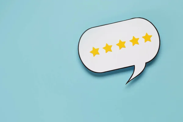 Speech bubble with five stars rating on blue background. Customer experience concept