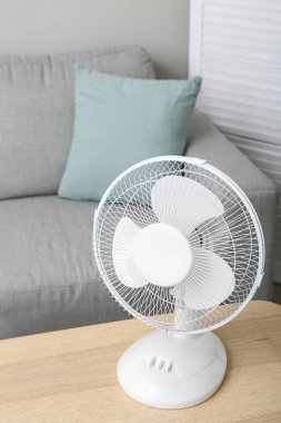Modern elektrikli vantilatör oturma odasındaki masada.