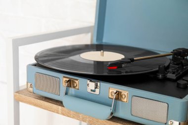 Tahta rafta vinil diski olan kayıt çalar
