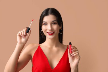 Kahverengi arka planda kırmızı ruju olan güzel bir genç kadın.