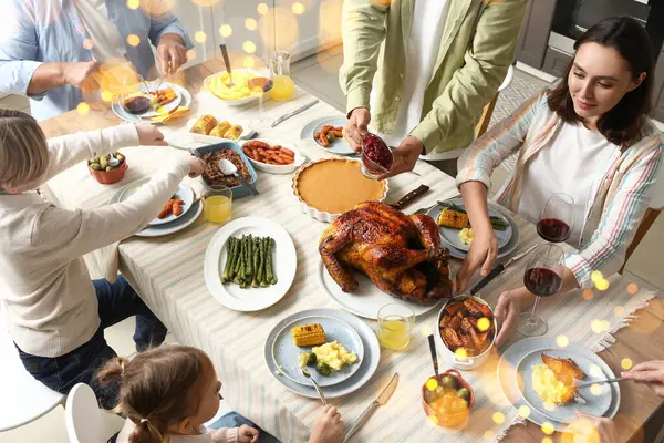 Happy family having dinner on Thanksgiving Day