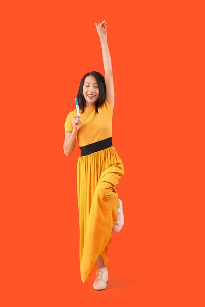 Happy Young Asian Woman Pregnancy Test Orange Background — Stock Photo, Image