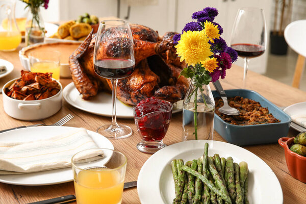 Festive dining table with tasty food for Thanksgiving Day in kitchen, closeup