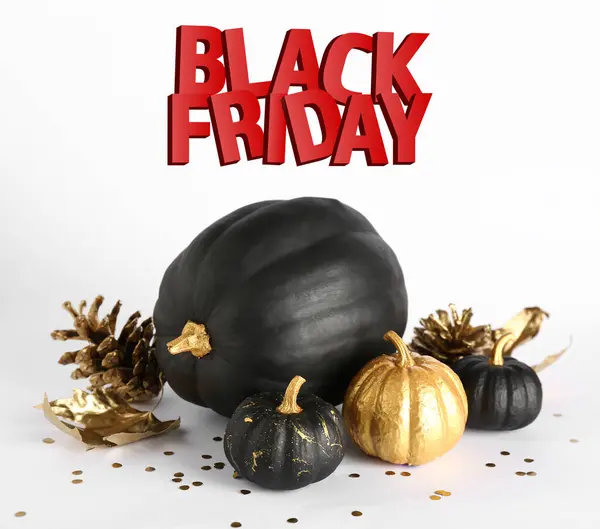 Painted pumpkins, cones and text BLACK FRIDAY on white background