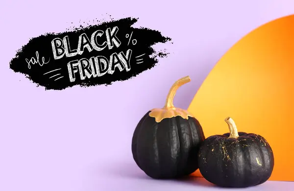 Painted pumpkin and text BLACK FRIDAY on color background