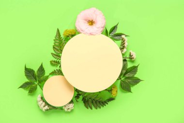 Boş kağıt kağıtlar ve yeşil arka planda güzel çiçekler olan kompozisyon