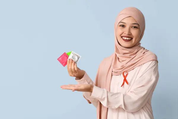 Beautiful Muslim Woman Red Ribbon Condoms Blue Background Aid Awareness — Stock Photo, Image
