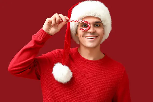Young Man Santa Hat Candy Cane Red Background — Stock Photo, Image