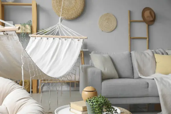 Cozy white hammock in interior of living room