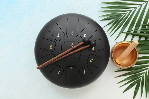 stock image Glucophone with sticks, tibetan singing bowl and palm leaves on gradient background