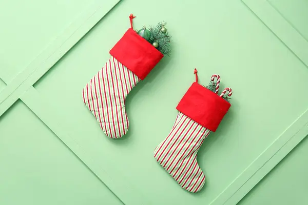 Christmas Socks Fir Branches Balls Candy Canes Hanging Green Background — Stock Photo, Image