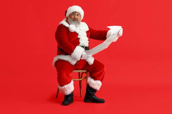Santa Claus Reading Letter Red Background — Stock Photo, Image