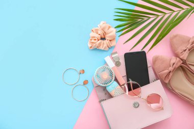 Taşınabilir elektrikli vantilatör, modern cep telefonu ve renkli arka planda şık kadın aksesuarları olan kompozisyon