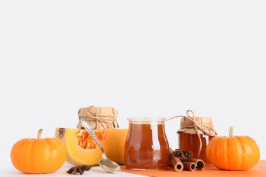 Tarçınlı balkabağı reçeli kavanozlar ve renkli arka planda yıldız anason.