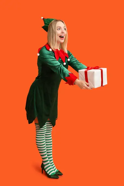 Emotional Young Woman Elf Costume Christmas Gift Box Orange Background — Stock Photo, Image