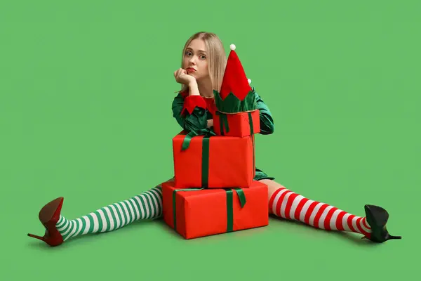 Sad Young Woman Elf Costume Christmas Gift Boxes Green Background — Stock Photo, Image
