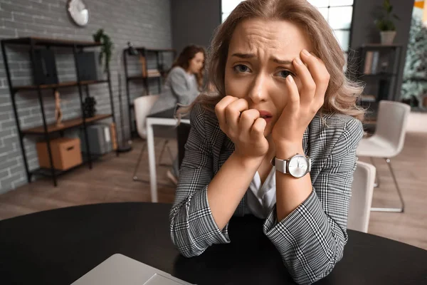 Young woman having panic attack in office