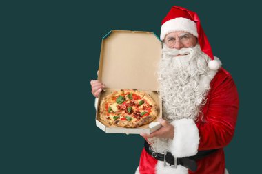 Noel Baba yeşil arka planda bir kutu lezzetli pizzayla