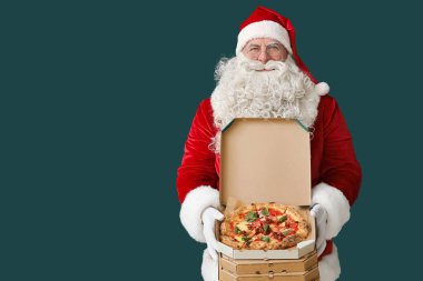 Noel Baba yeşil arka planda bir kutu lezzetli pizzayla