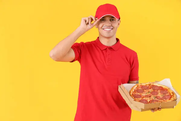 Male Courier Tasty Pepperoni Pizza Yellow Background — Stock Photo, Image