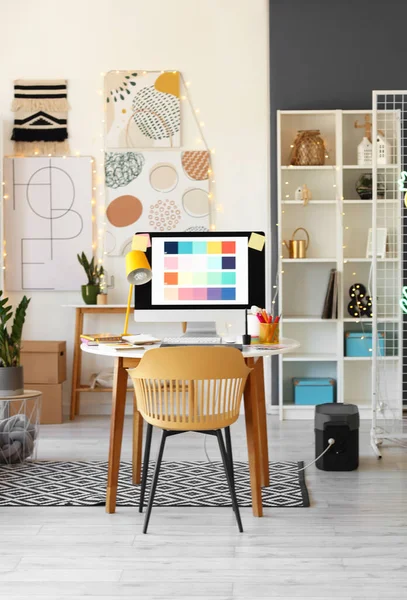Graphic designer\'s workplace with computer in interior of office
