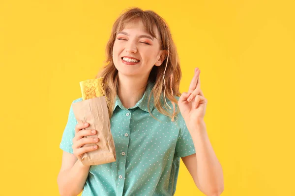 Young Woman Tasty Sandwich Wrap Crossing Fingers Yellow Background — Stock Photo, Image