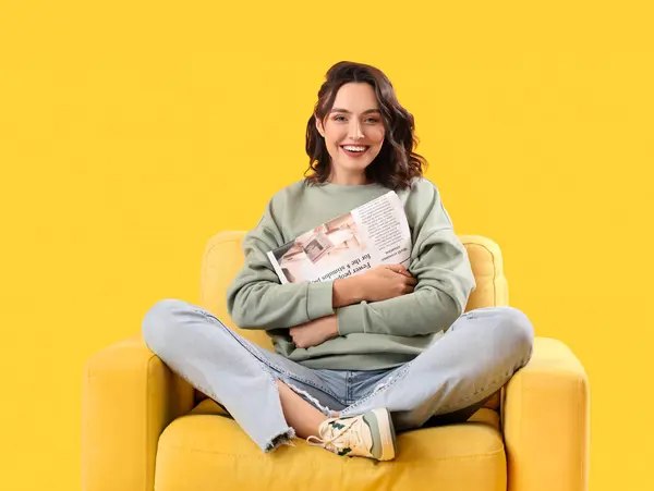 Junge Frau Mit Zeitung Sessel Auf Gelbem Hintergrund — Stockfoto