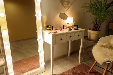 Parlak aynalı ve tuvalet masalı karanlık makyaj odasının içi.