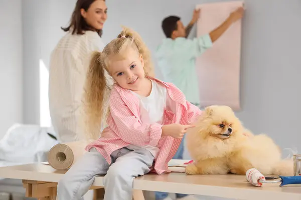 Little girl with cute dog during repair of her new house