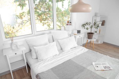 Büyük yataklı ve masalı bir otel odası.