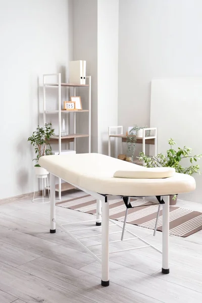 Interior of beauty salon with massage table