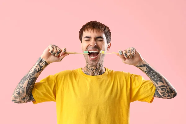 Jovem Homem Tatuado Com Escovas Dentes Fundo Rosa — Fotografia de Stock