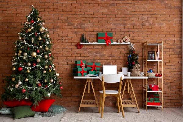 Interior of office with workplace, presents and Christmas trees