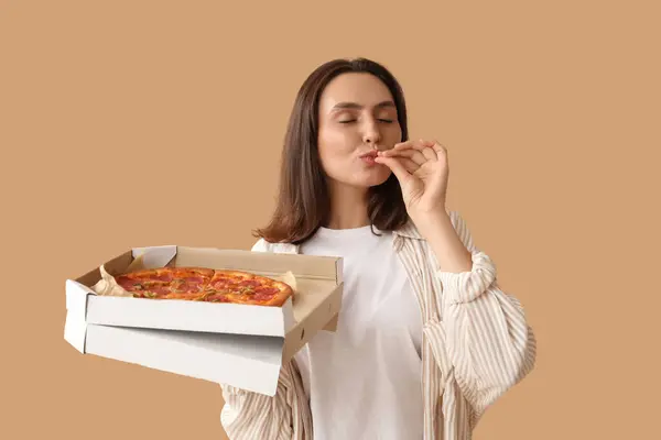 Young Woman Holding Cardboard Box Tasty Pizza Beige Background — Stock Photo, Image