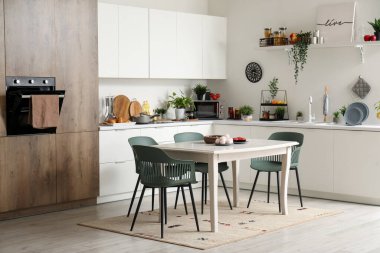 Modern mutfak ve beyaz yemek masası.