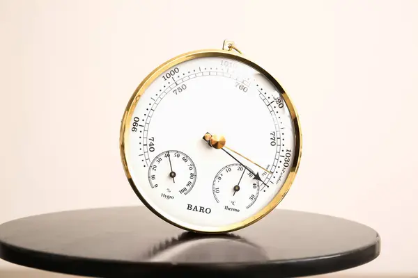 Stock image Aneroid barometer on black table, closeup