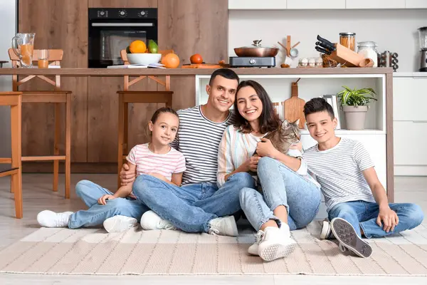 Mutfakta kedisi olan mutlu bir aile.