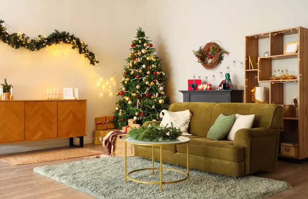 Interior of living room with sofa, Christmas tree and glowing lights