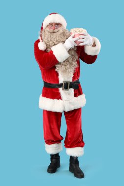 Mavi arka planda lezzetli patlamış mısırlı Noel Baba